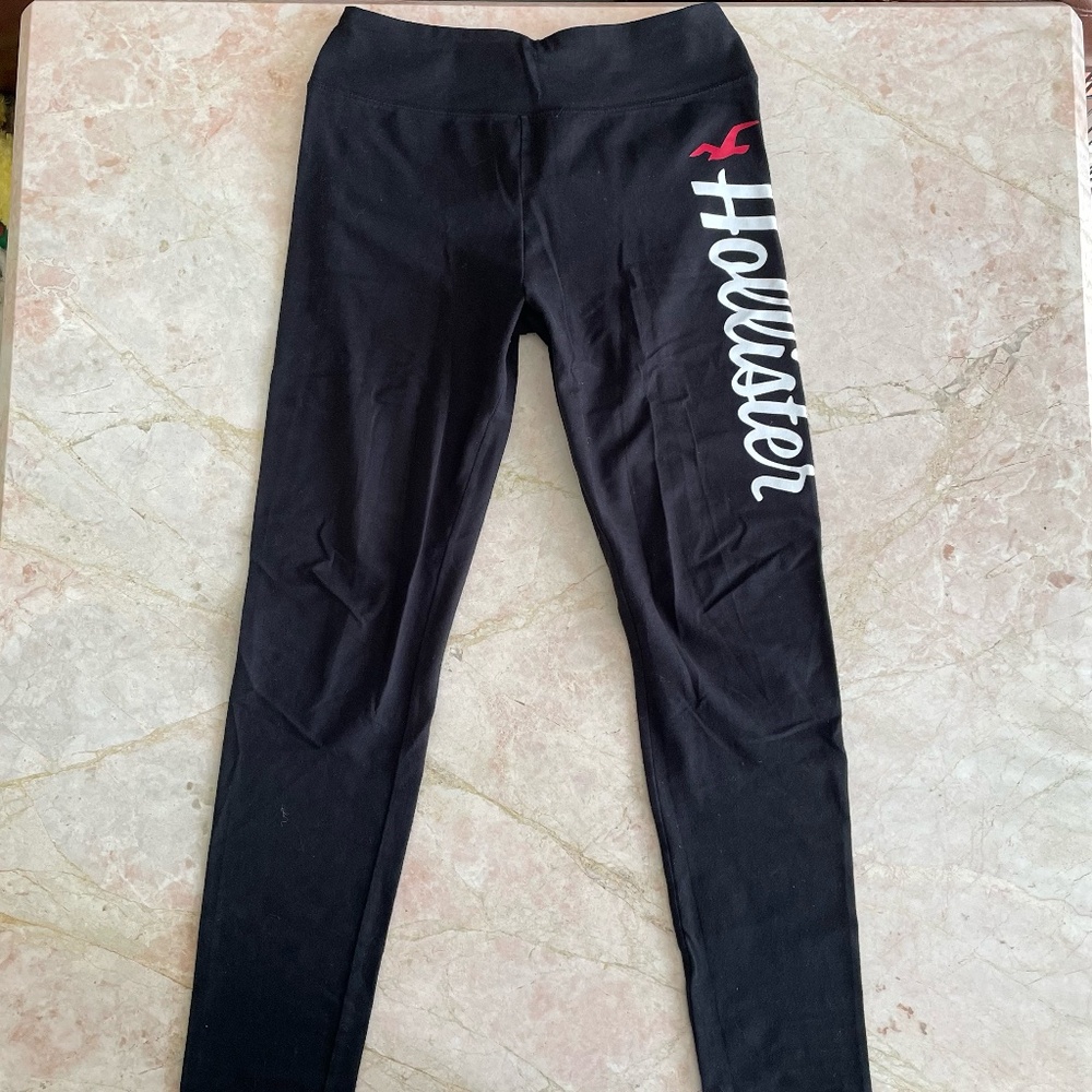 Black Hollister Co. leggings with white and red lettering